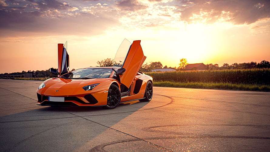 Orange Lamborghini Aventador with Scissor Doors Open at Sunset on an Empty Airfield HD wallpaper