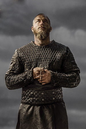 Ragnar Lothbrok from Vikings TV Series in Leather Armor Holding Cross HD phone wallpaper