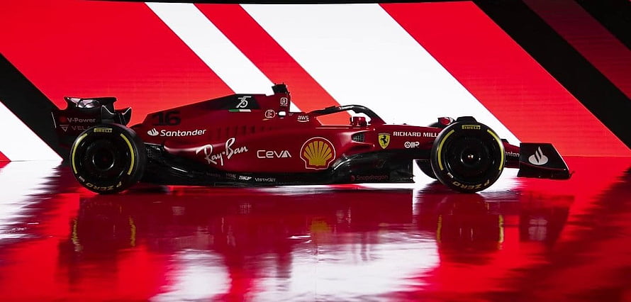 Ferrari F1 75 Formula One Race Car with Shell and Santander Sponsors on Red Stage HD wallpaper