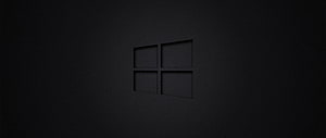 Windows 10 Dark Minimalist Desktop Background with Subtle Logo on Black Surface HD wallpaper