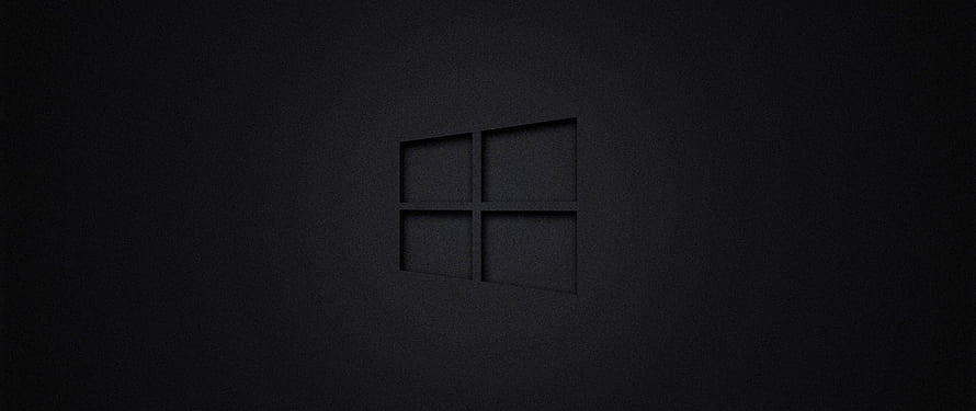 Windows 10 Dark Minimalist Desktop Background with Subtle Logo on Black Surface HD wallpaper