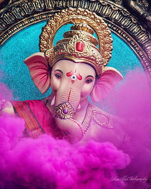 Vibrant Ganesha Idol Surrounded by Pink Holi Colors and Golden Crown HD phone wallpaper