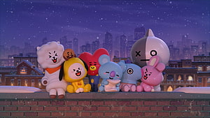 BT21 Characters Sitting on a Rooftop Wall in a Snowy Night Cityscape HD wallpaper