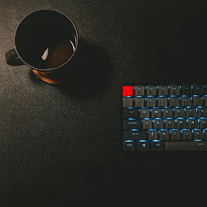 Minimalist Dark Desk Setup with Backlit Mechanical Keyboard and Coffee Mug HD phone wallpaper
