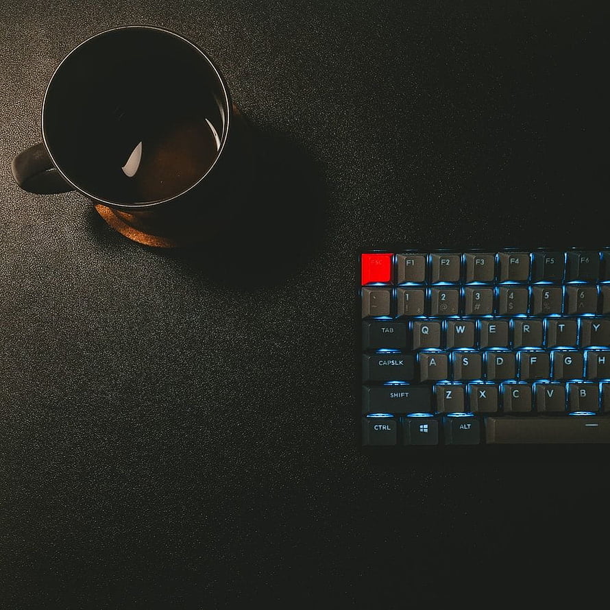 Minimalist Dark Desk Setup with Backlit Mechanical Keyboard and Coffee Mug HD phone wallpaper