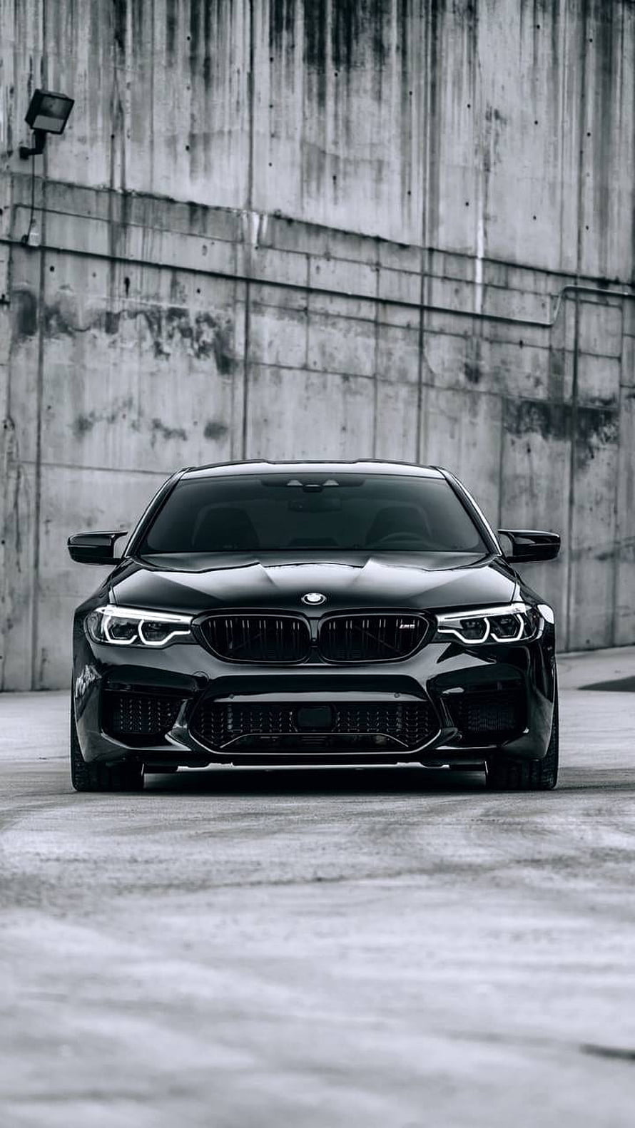 Black BMW M5 Competition Front View Against Concrete Wall HD phone wallpaper