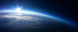Sunrise Over Earth Horizon From Space With Blue Atmosphere And Clouds HD wallpaper