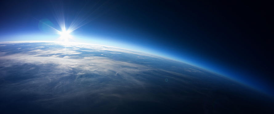 Sunrise Over Earth Horizon From Space With Blue Atmosphere And Clouds HD wallpaper