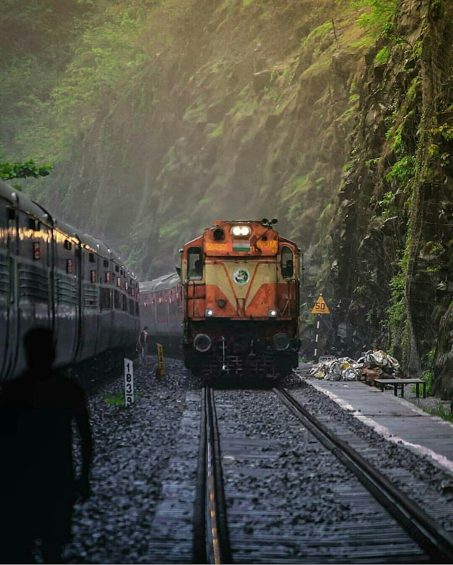 Orange Indian Railways Locomotive Emerging from Mountain Tunnel HD phone wallpaper
