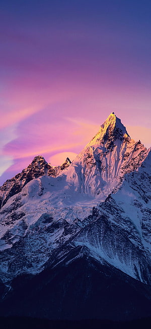 Majestic Snow-Capped Mountain Peak Bathed in Golden Sunset Light Against a Purple Sky HD phone wallpaper