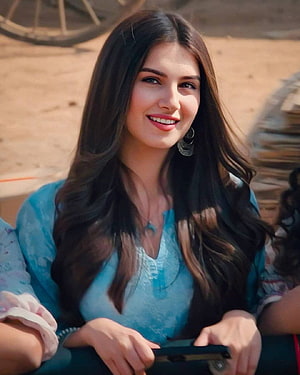 Tara Sutaria in Marjaavaan wearing a light blue top with long dark hair and a warm smile HD phone wallpaper