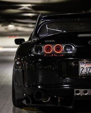 Black Toyota Supra Rear View with Carbon Fiber Spoiler and Quad Exhaust in Parking Garage HD phone wallpaper