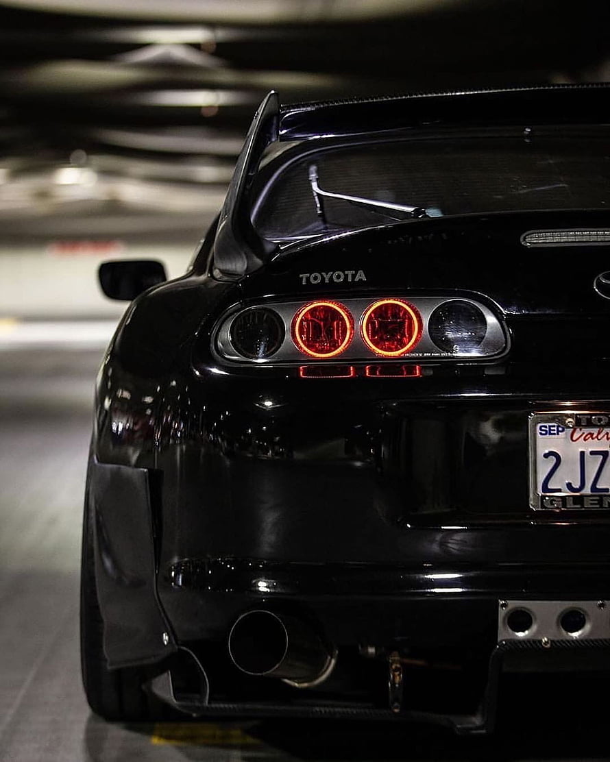 Black Toyota Supra Rear View with Carbon Fiber Spoiler and Quad Exhaust in Parking Garage HD phone wallpaper