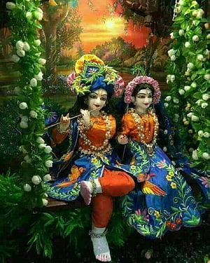 Radha Krishna Sitting on Swing with Peacock Feathers and Floral Garlands HD phone wallpaper