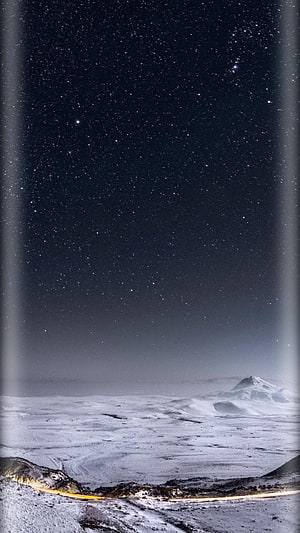 Starry Night Sky Over Snowy Mountain Landscape With Light Trails HD phone wallpaper