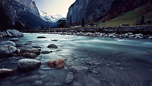 Serene Alpine River Flowing Through Rocky Valley With Snow-Capped Mountains HD wallpaper