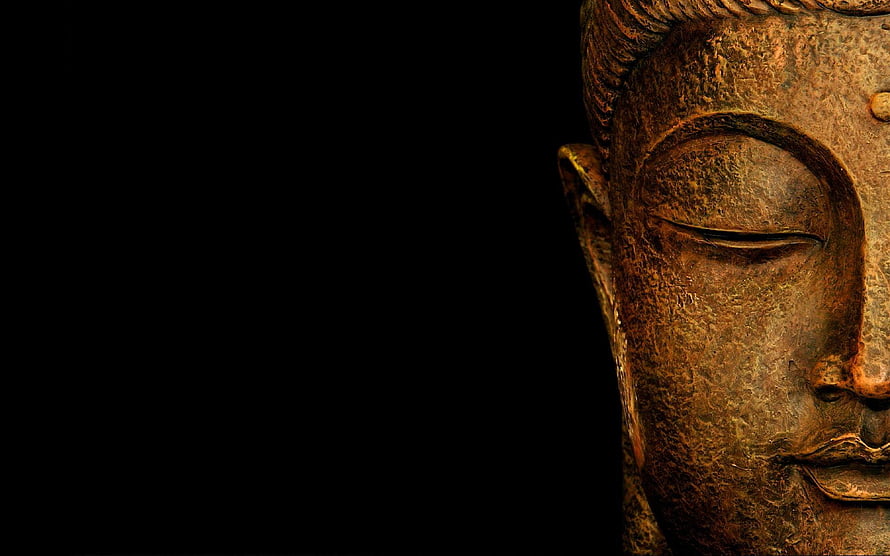 Close-up of a serene Buddha statue face with closed eyes against a dark background HD wallpaper