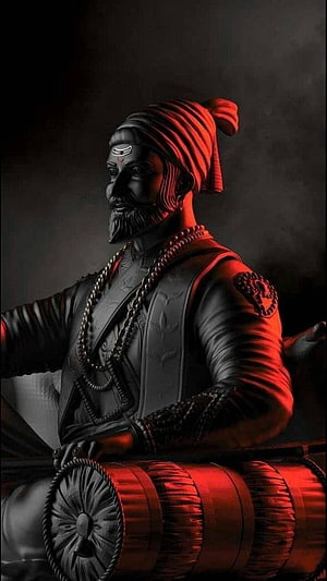 Statue of Saint Dadiyarpit playing the Dholak with dramatic red lighting HD phone wallpaper