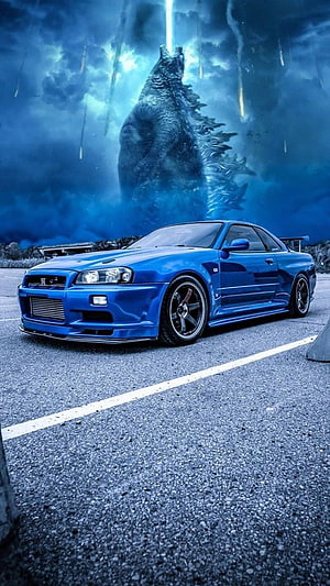 Blue Nissan Skyline R34 GT-R with Godzilla Roaring in Stormy Background HD phone wallpaper