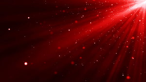 Crimson Light Rays and Glowing Particles Against a Deep Red Gradient Background HD wallpaper
