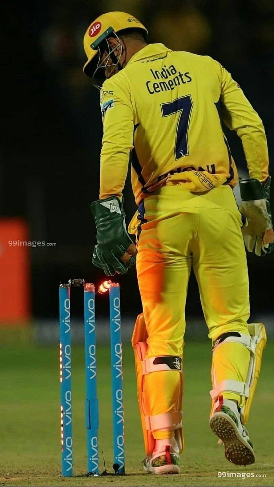 Cricket player in yellow Chennai Super Kings jersey walking away from stumps HD phone wallpaper