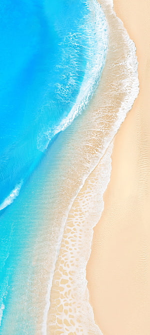 Aerial View of Turquoise Ocean Waves Washing Over Golden Sandy Beach HD phone wallpaper
