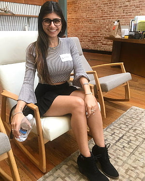 Mia Khalifa in Striped Top and Black Skirt Seated in Modern Lounge HD phone wallpaper