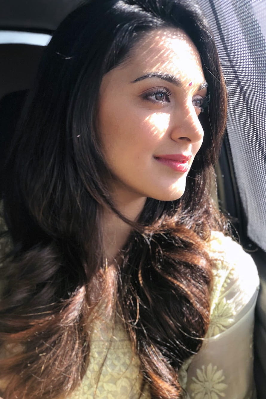 Kiara Advani in a Sunlit Car Portrait Wearing a Floral Blouse HD phone wallpaper