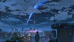 Anime boy watching blue meteor shower over city skyline at night HD wallpaper