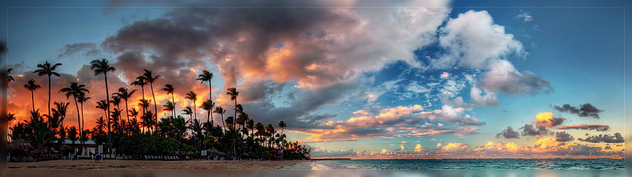 Panoramic Tropical Beach Sunset with Palm Trees and Dramatic Clouds HD wallpaper