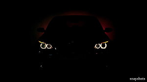 BMW M5 E60 Front Headlights Glowing in Darkness with Red Ambient Light HD wallpaper
