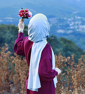 Woman in hijab holding pink roses against scenic mountain backdrop, Hijab Girl, aesthetic girl hijab HD phone wallpaper