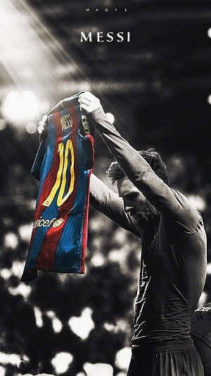 Lionel Messi holding up FC Barcelona jersey with number 10 in stadium HD phone wallpaper