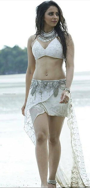 Rakul Preet Singh in a white bohemian beach outfit with silver jewelry and wet hair HD phone wallpaper