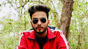 Portrait of a man wearing a red track jacket and aviator sunglasses in a forest, Elvish Yadav 41766, #elvish yadav HD wallpaper