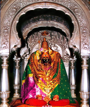Ornate Hindu Deity Statue Adorned in Gold Jewelry and Green Silk Garments HD phone wallpaper