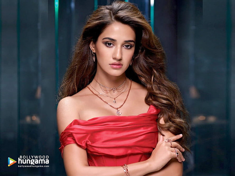 Disha Patani in a Red Off-Shoulder Gown with Layered Jewelry and Long Wavy Hair HD wallpaper