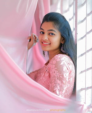 Young woman in pink lace dress smiling by window with sheer curtain, Naachiyaar Ivana alessandroorsini, aleena shaji HD phone wallpaper