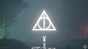 Glowing Deathly Hallows Symbol Hovering Over a Misty Forest with a White Deer HD wallpaper