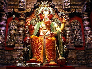Ganesha Statue in Temple with Intricate Carvings and Golden Decorations HD wallpaper