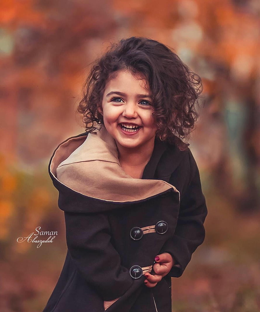 Anahita Hashemzadeh Smiling in a Black Coat Against an Autumn Background HD phone wallpaper