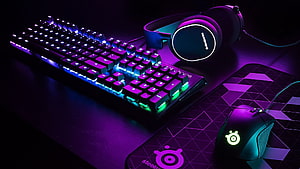 SteelSeries Gaming Setup with RGB Keyboard, Mouse, and Headset on Dark Desk HD wallpaper