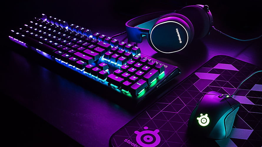 SteelSeries Gaming Setup with RGB Keyboard, Mouse, and Headset on Dark Desk HD wallpaper