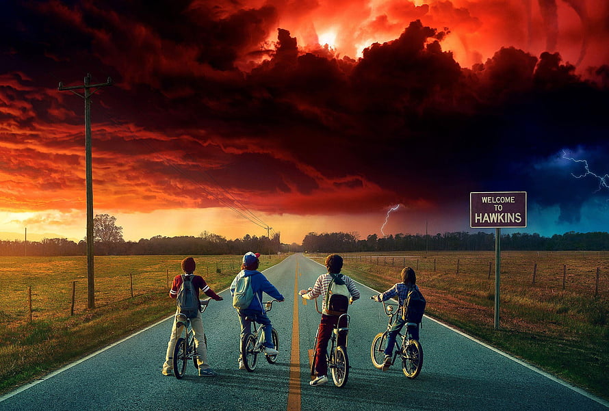 Stranger Things Season 3 Four Boys Riding Bikes on Hawkins Road Under Dramatic Stormy Sky HD wallpaper