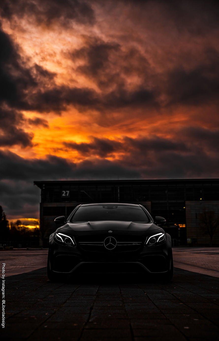 Black Mercedes-Benz C-Class Coupe Under Dramatic Orange Sunset Sky HD phone wallpaper