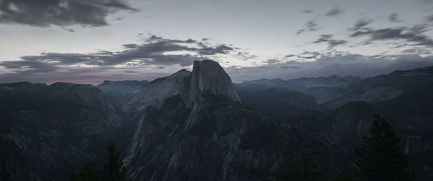Half Dome at Dusk in Yosemite National Park with Dramatic Clouds and Valley Mist HD wallpaper