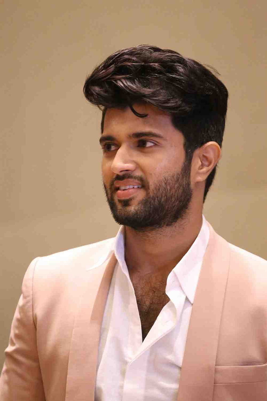 Vijay Deverakonda in a beige blazer and white shirt with styled hair and beard HD phone wallpaper