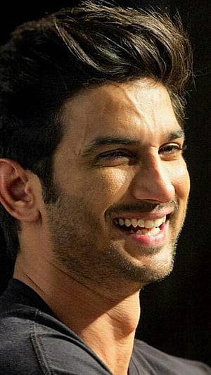 Sushant Singh Rajput smiling portrait with dark background HD phone wallpaper