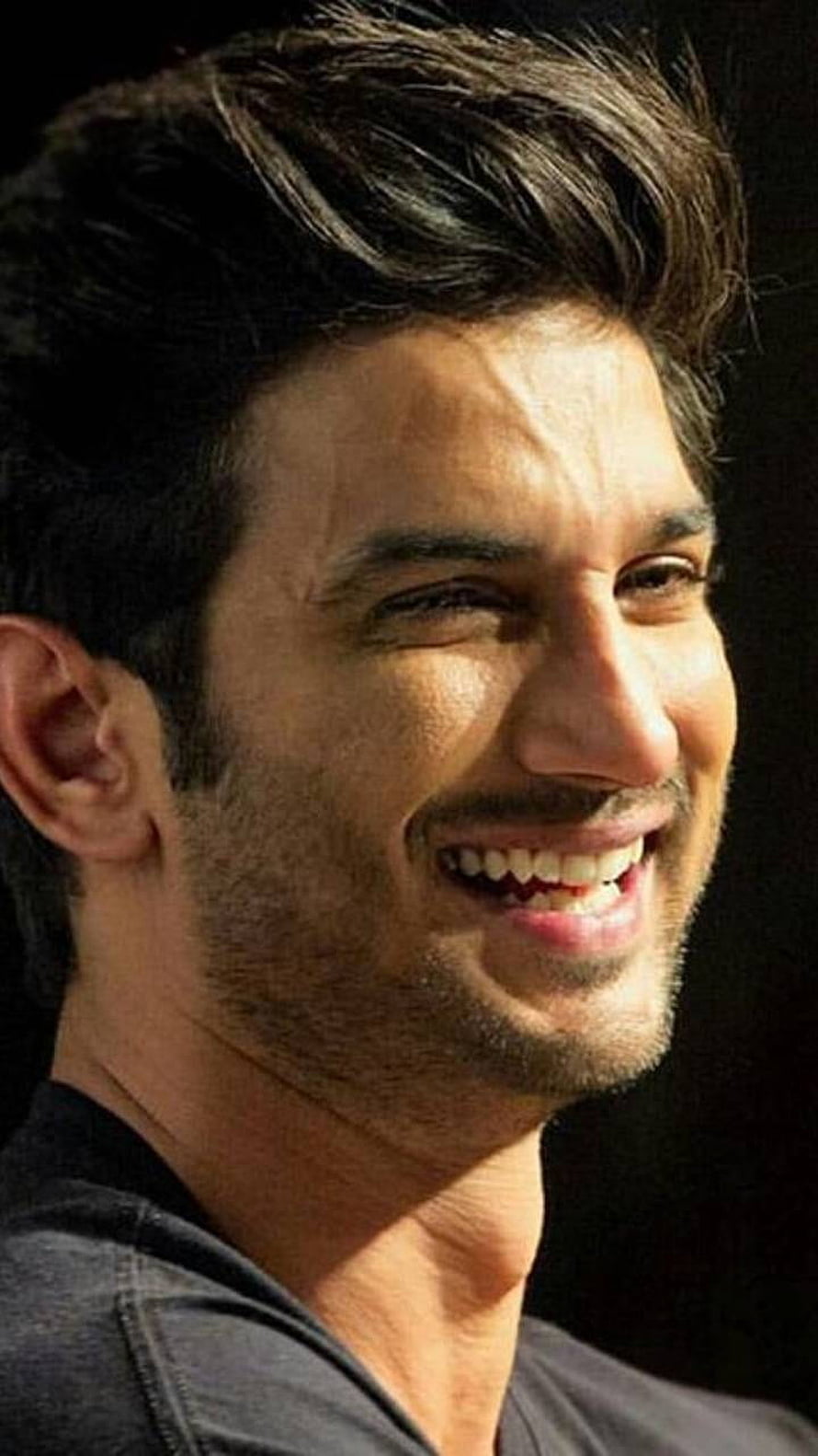 Sushant Singh Rajput smiling portrait with dark background HD phone wallpaper