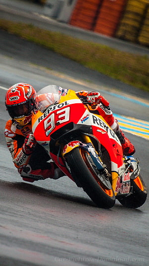 MotoGP Rider Leaning Into Corner on Repsol Honda Racing Motorcycle HD phone wallpaper